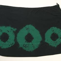 Black mini skirt with three tye-dyed green rings.