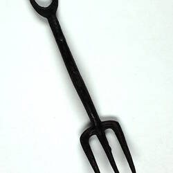 Toy pitchfork lying down.