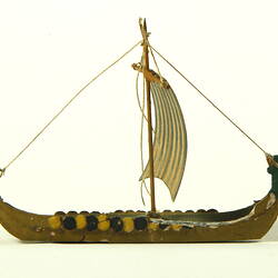 Side view of single masted ship with curved ends.