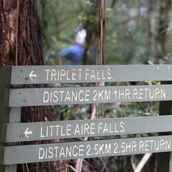 Signage for Triplet Falls, distance 2km 1hr return, and Little Aire Falls, distance 2.5km 2.5hr return.