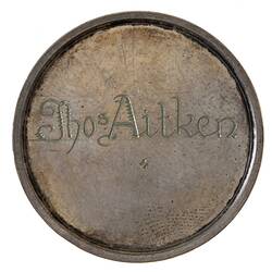 Round silver plain medal with name engraved in centre.