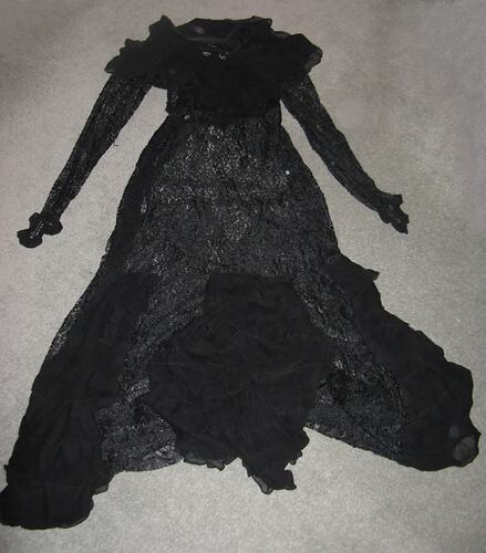 Black lace dress, full length with high frill neck and long sleeves.