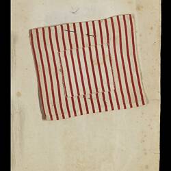Page 12 of an unbound book containing a sewing sample. Red and white striped piece of fabric.
