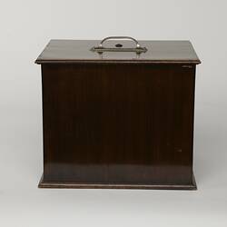 Brown wooden box with top handle. Back view.