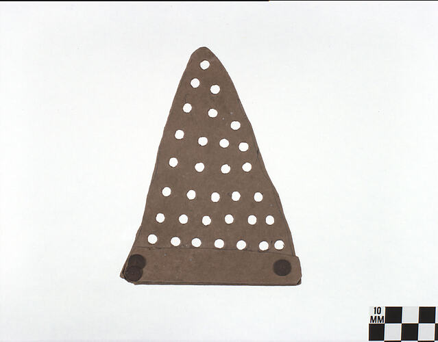 Two dimensional brown cardboard conical shaped hat with drilled holes.