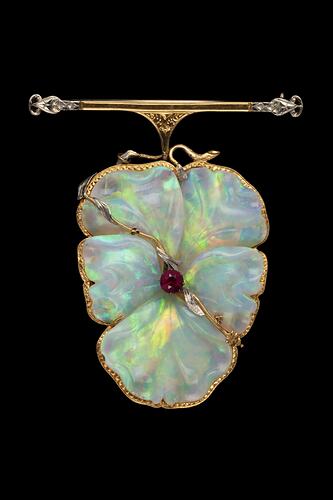 White opal, gold and silver brooch in the shape of a flower.