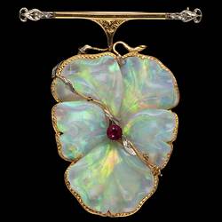White opal, gold and silver brooch in the shape of a flower.