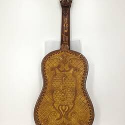 Back view of decorative brown wooden mandolin.