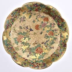 Top view of cream coloured compote with wavy edges decorated with birds & chrysanthemums.