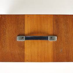Top view of rectangular wooden box with handle on top.