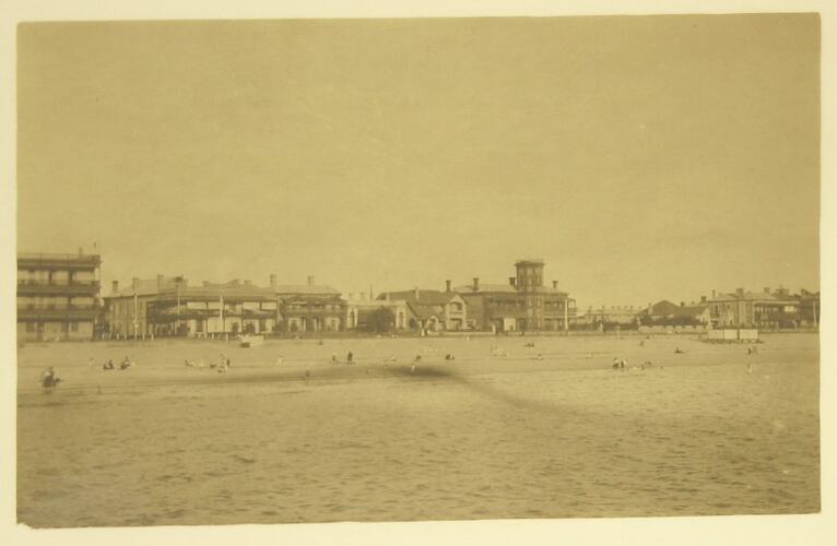 Beach with buildings along foreshore.
