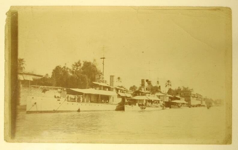 Passanger transport boats anchored on bank of river.