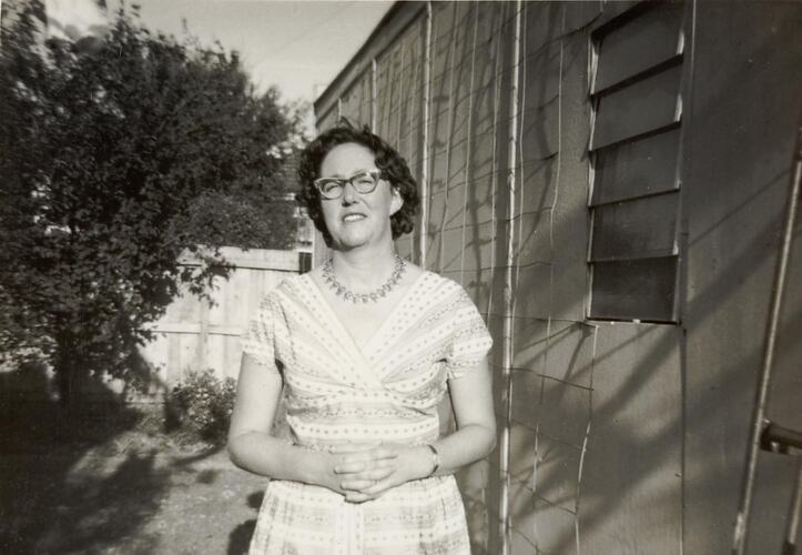 Digital Photograph - Woman in Backyard by Garage, Hampton, 1960