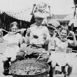 Digital Photograph - Holden Brothers Circus, Three Children & Man Holding Blue Crabs in front of circus trucks, Port Lincoln, South Australia, early 1930s