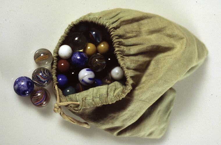 Marbles in bag - Green cloth