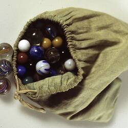 Marbles in bag - Green cloth