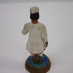 Little clay figure showing the back of an Indian man.