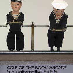 Detail of painted wooden men in sailor suits.