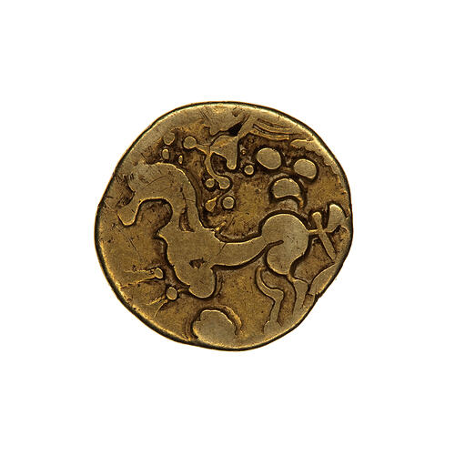 Coin, round, horse advancing to the left with a crudely formed figure of winged female flying above.