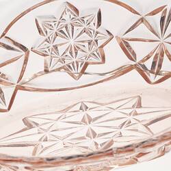 Pink glass vase with cut patterns.