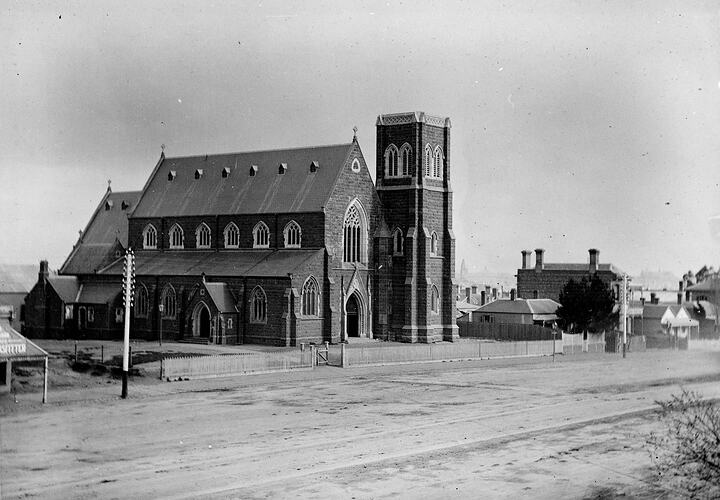 Church with dirt road in the foreground.