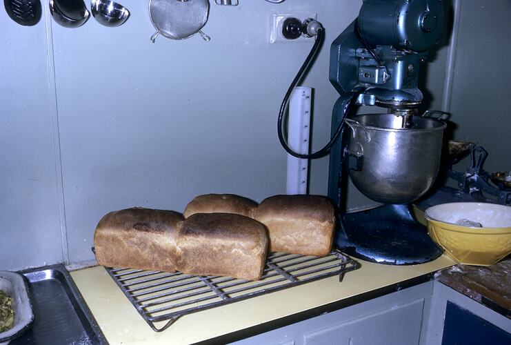 Kitchen with loaves of bread and mixer.