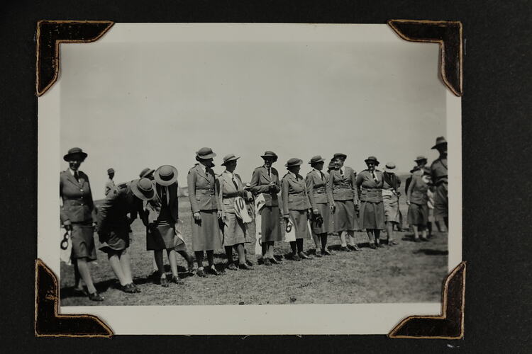 Women in uniform standing in a row.