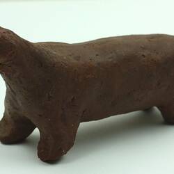 Toy dog made from clay, side view.