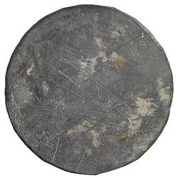 Round dull bronze medal with uneven edges. Blank face has scratches.