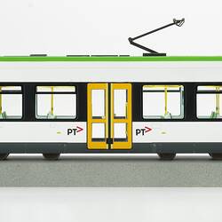 Tram model of green and white articulated, low-floor tram.