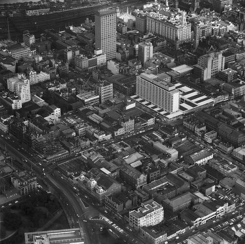 Black and white aerial cityscape of Melbourne.