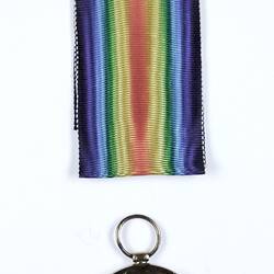 Round medal with angel and rainbow coloured ribbon.
