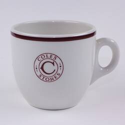 Ceramic cup with Coles Stores logo on front.