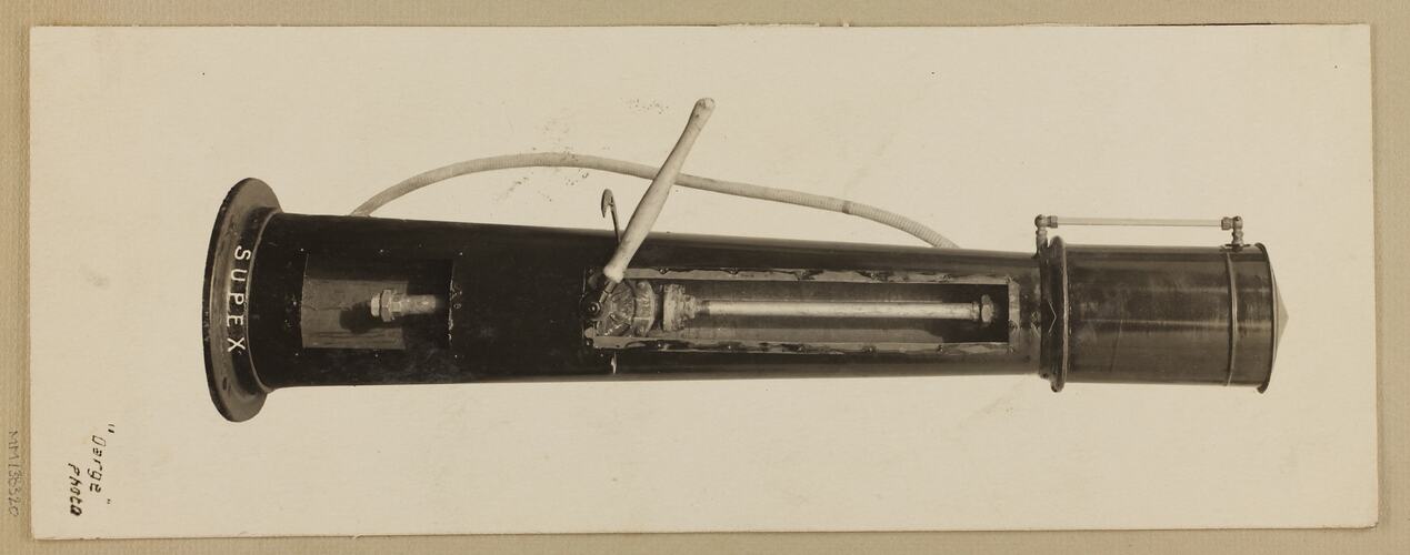 Monochrome photograph of a single cylinder petrol pump.