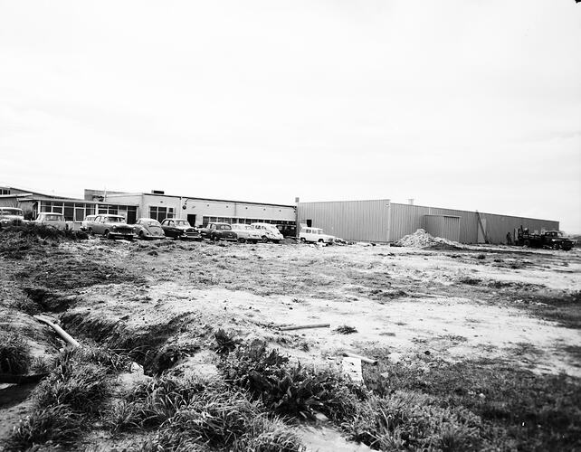 Monochrome image of a factory exterior.