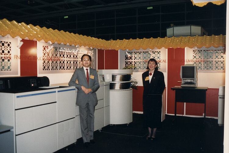 Two people inside Kodak exhibition stand.