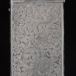 Back of silver cigar case with detailed engraved pattern. Hinged lid. Hallmark stamp.
