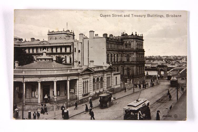 Front of postcard showing city scene.