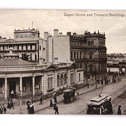 Front of postcard showing city scene.