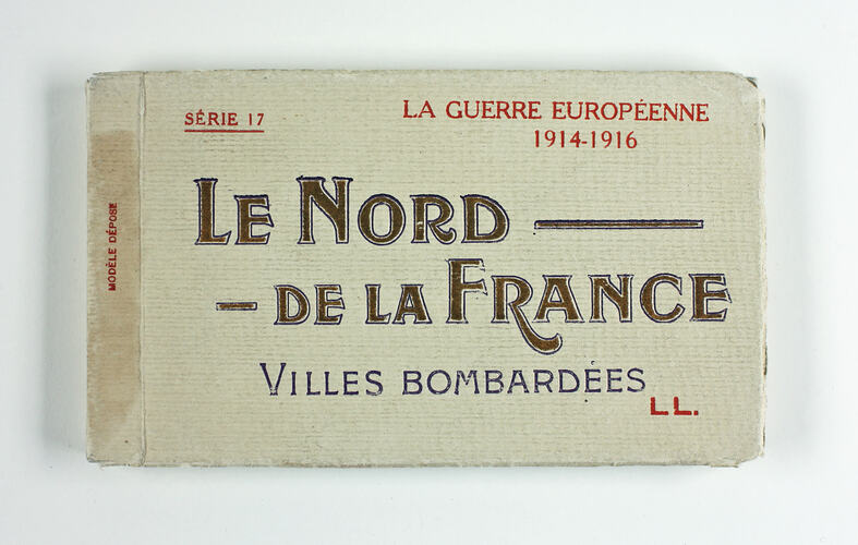 Cover of postcard album with printed text.