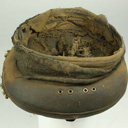Three-quarter underside view of old battered nightsoil collector's khaki flat top cap