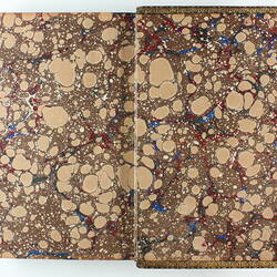 Open book with brown and beige marbled design on both sides.