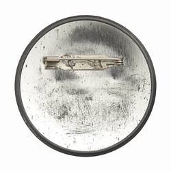 Metal back of round badge. Horizontal pin.
