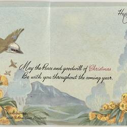 Card with brown and white kookaburra flying over yellow flowering gum branches. Printed cursive text.
