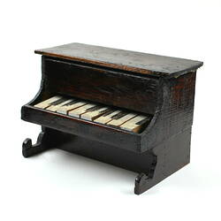Dark brown toy piano.