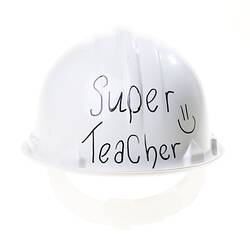 Back of white plastic hard hat with black handwriting.