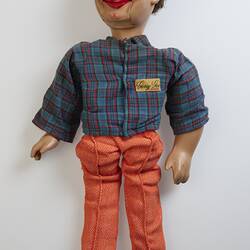 Doll with red pants, blue top and short brown hair.