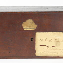 Wooden rectangular box with paper label.