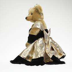 Profile, light brown bear in black velvet and gold lame gown. Faux diamond, amethyst tiara, necklace, earrings