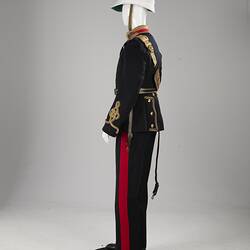 Profile of navy officer's uniform with gold at cuff, sash, epaulettes, belt. Red/gold collar. White helmet.
